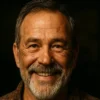 Hank Miller, experienced mechanic and founder of Hydraulic Tools Shop, smiling in his workshop.